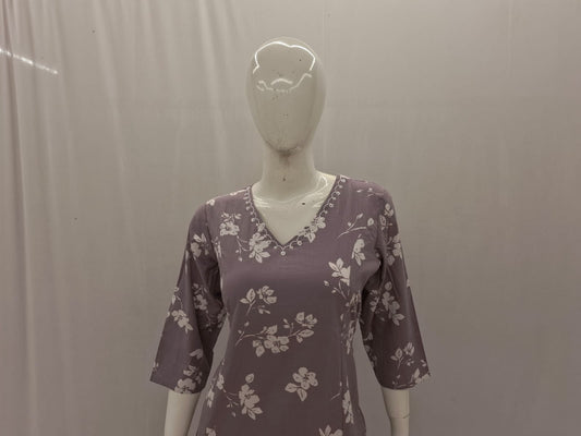 Mannequin wearing a purple floral dress against a plain background