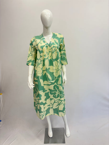 Mannequin wearing a green and yellow floral dress on a white background