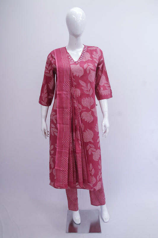 Red patterned kurta set on a mannequin against a white background