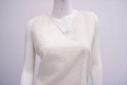 White sleeveless sweater on a mannequin against a white background