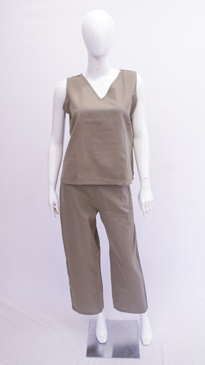 Mannequin wearing a beige sleeveless top and pants on a white background