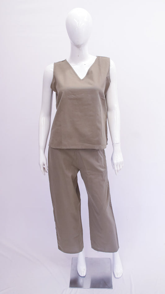 Mannequin wearing a beige sleeveless top and pants on a white background
