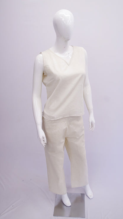 Mannequin wearing a white sleeveless top and pants on a white background