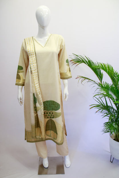 Mannequin wearing a beige dress with green patterns on a white background