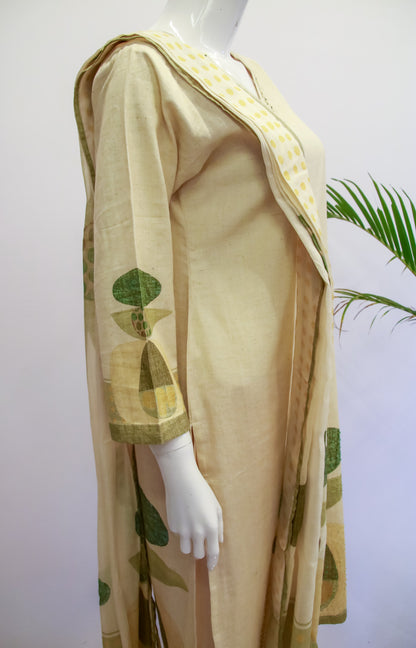 Mannequin wearing a beige outfit with green patterns on a white background