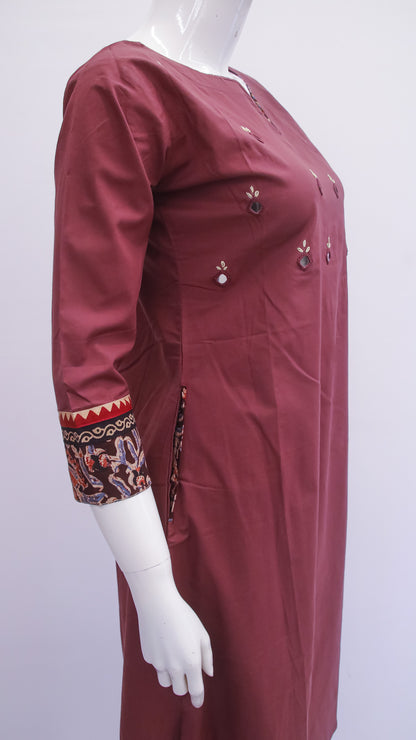 Maroon dress with intricate patterns on sleeves displayed on a mannequin against a white background