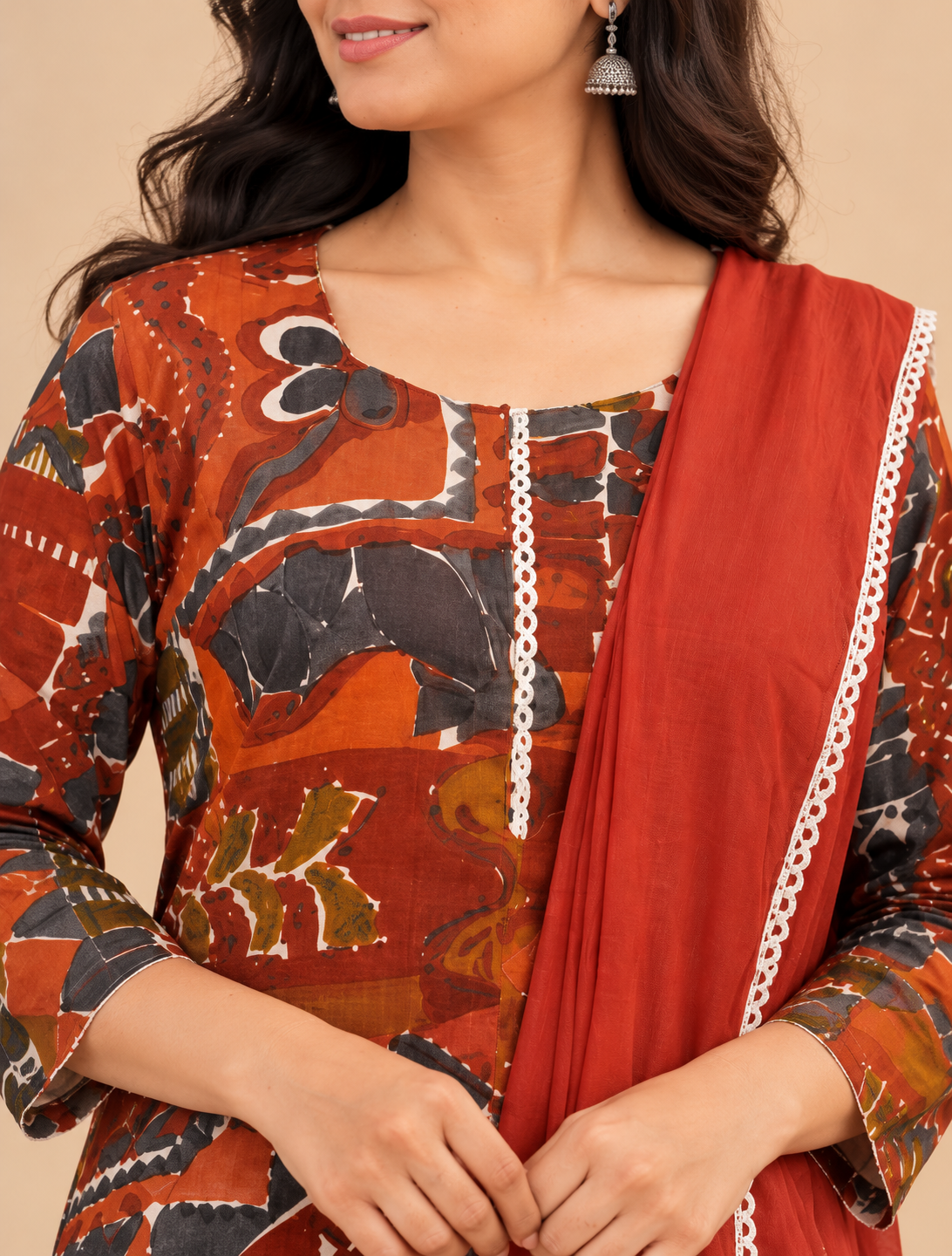 Rust red multicolour printed kurta pant set with matching lace-trimmed dupatta for women by Udojas Sutra.
