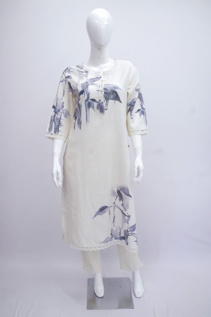 White dress with blue floral pattern on a mannequin against a white background