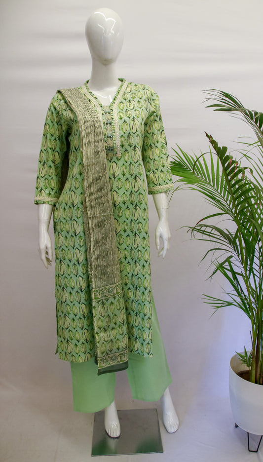Pista green cotton dupatta set displayed on a mannequin, consisting of a floral printed kurta, straight pants, and a dupatta with a V-neck style and 3/4th sleeves.
