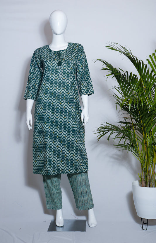 A green top and pant set displayed on a mannequin, featuring a straight neckline top and drawstring pants with a floral print pattern.