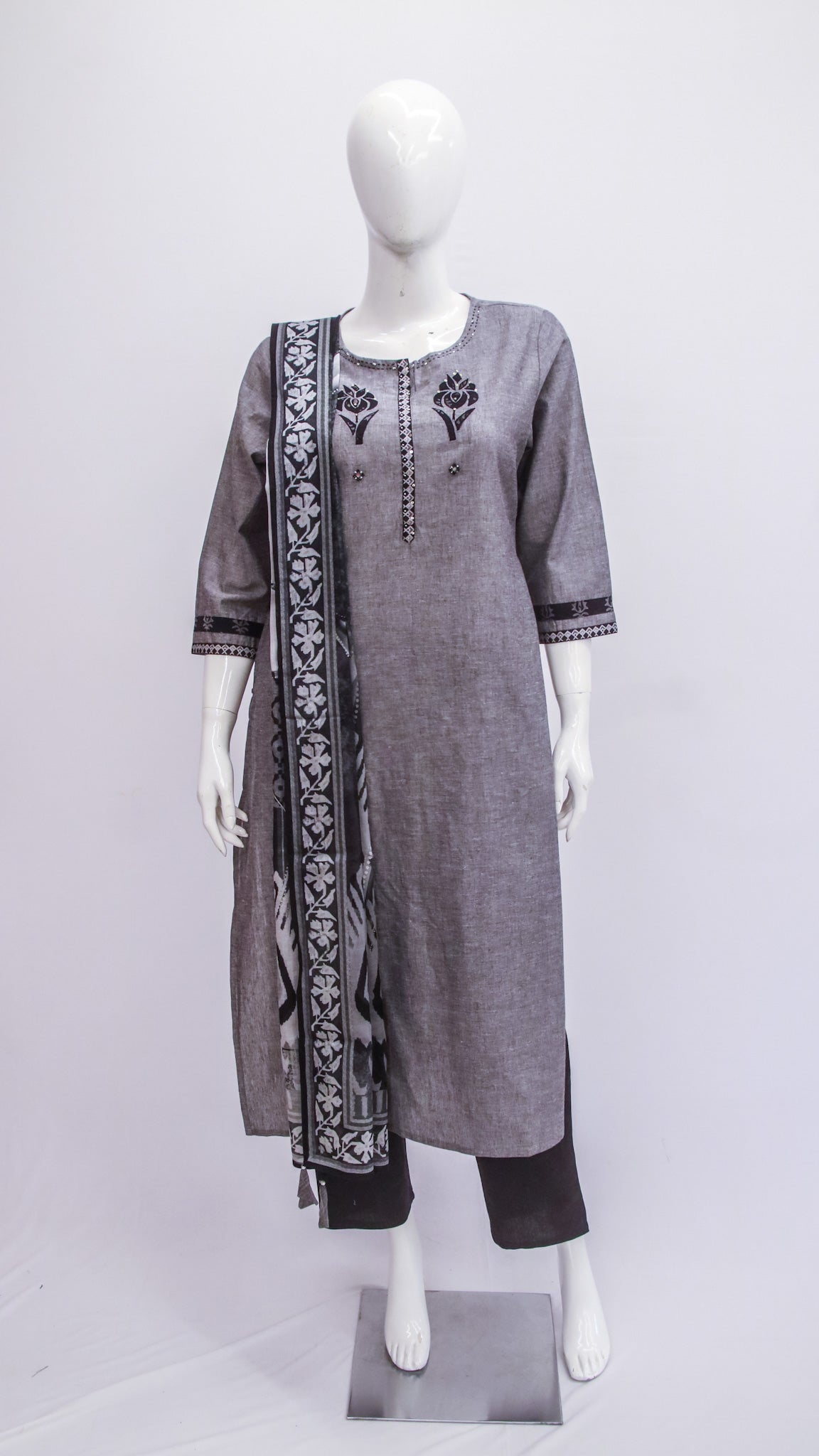 Gray embroidered kurta with black pants on a mannequin against a white background