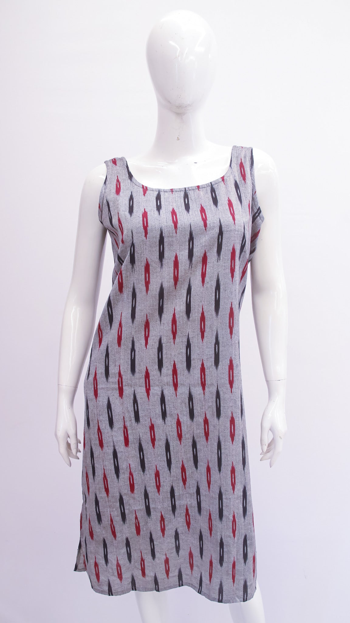 Mannequin wearing a sleeveless dress with a pattern on a white background