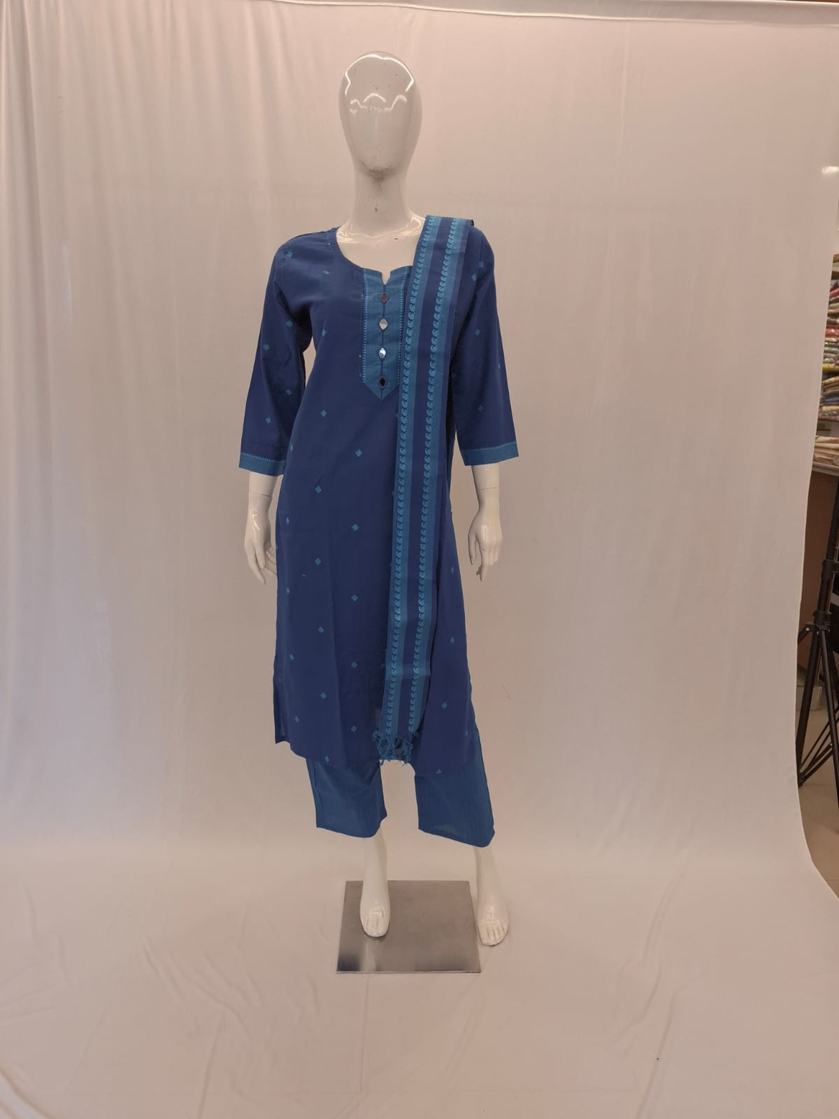 Blue traditional outfit on a mannequin against a white background