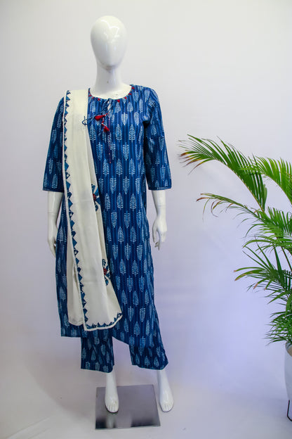 Blue patterned dress with white scarf on a mannequin against a white background