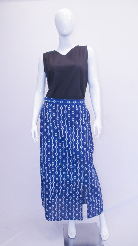 Mannequin wearing a black top and blue patterned skirt on a white background