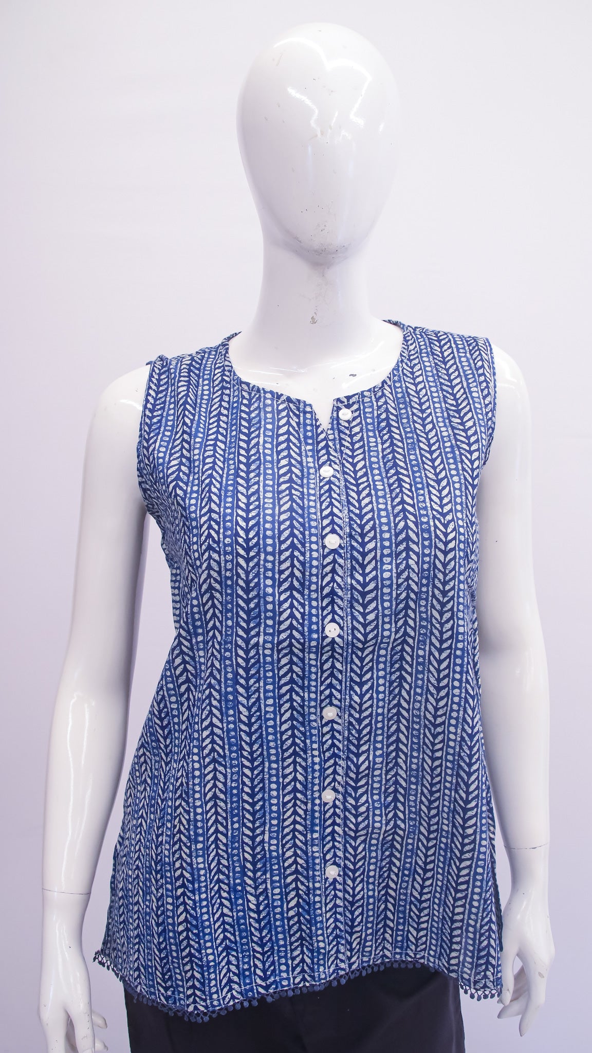 Blue patterned sleeveless top on a mannequin against a white background