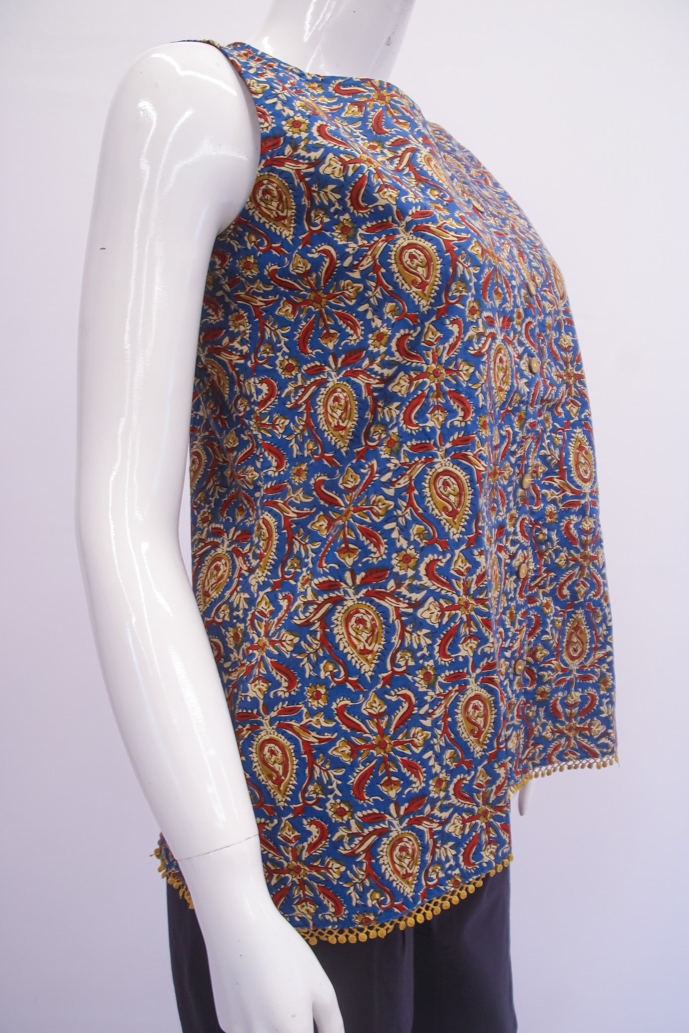 Mannequin wearing a colorful patterned top on a white background