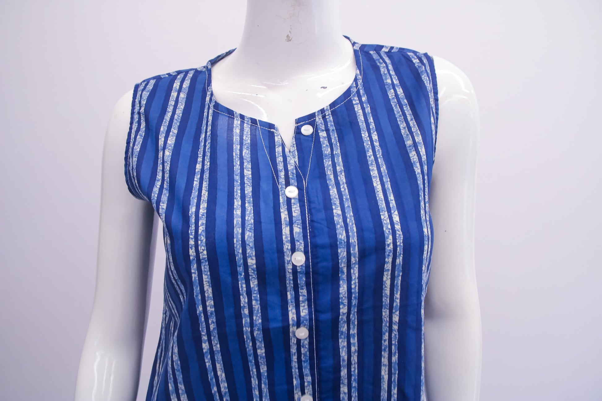 Blue and white striped sleeveless top on a mannequin against a light gray background