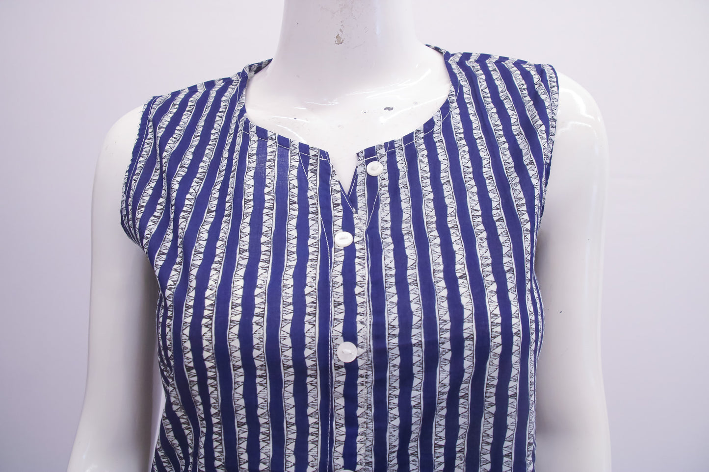 Blue and white striped sleeveless top on a mannequin against a plain background