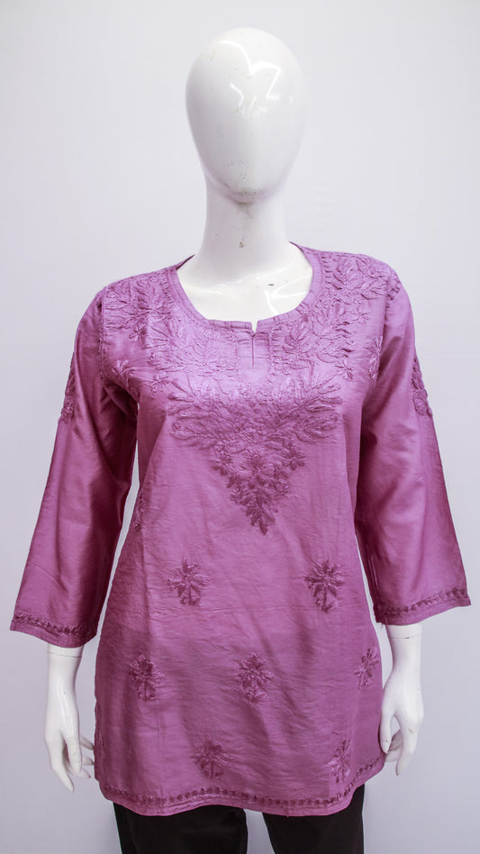 Purple embroidered top on a mannequin against a white background