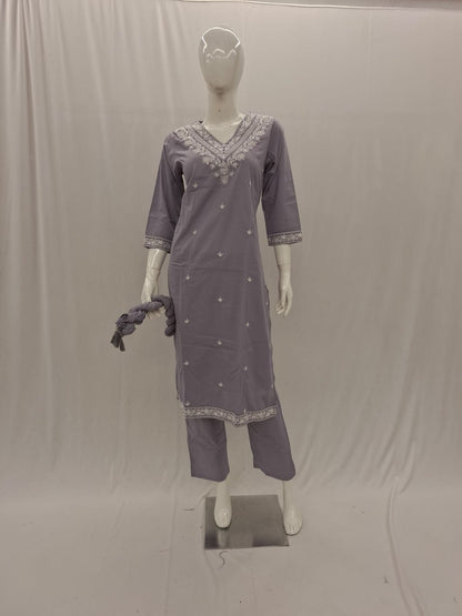 Mannequin wearing a gray traditional outfit with intricate designs on a plain background