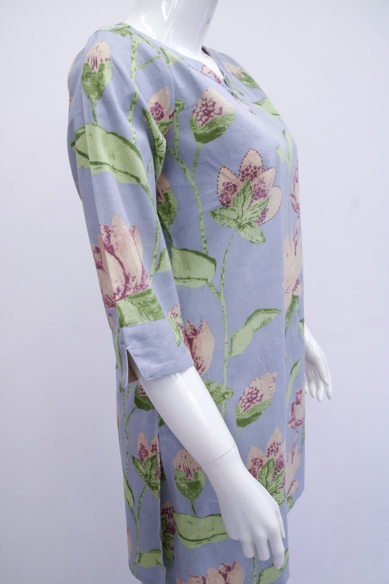 Mannequin wearing a floral dress with a light blue background