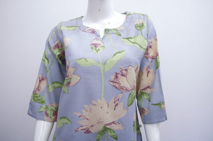 Floral-patterned shirt on a mannequin against a white background
