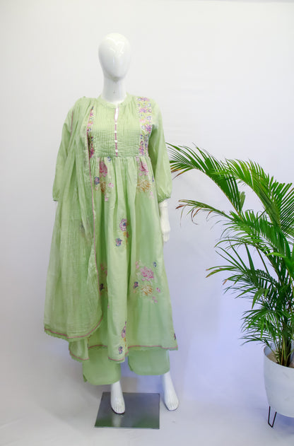 Light green traditional outfit with floral patterns on a mannequin against a white background.