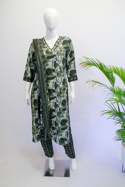 Women's green muslin kurta and pant set with matching dupatta featuring subtle floral prints"