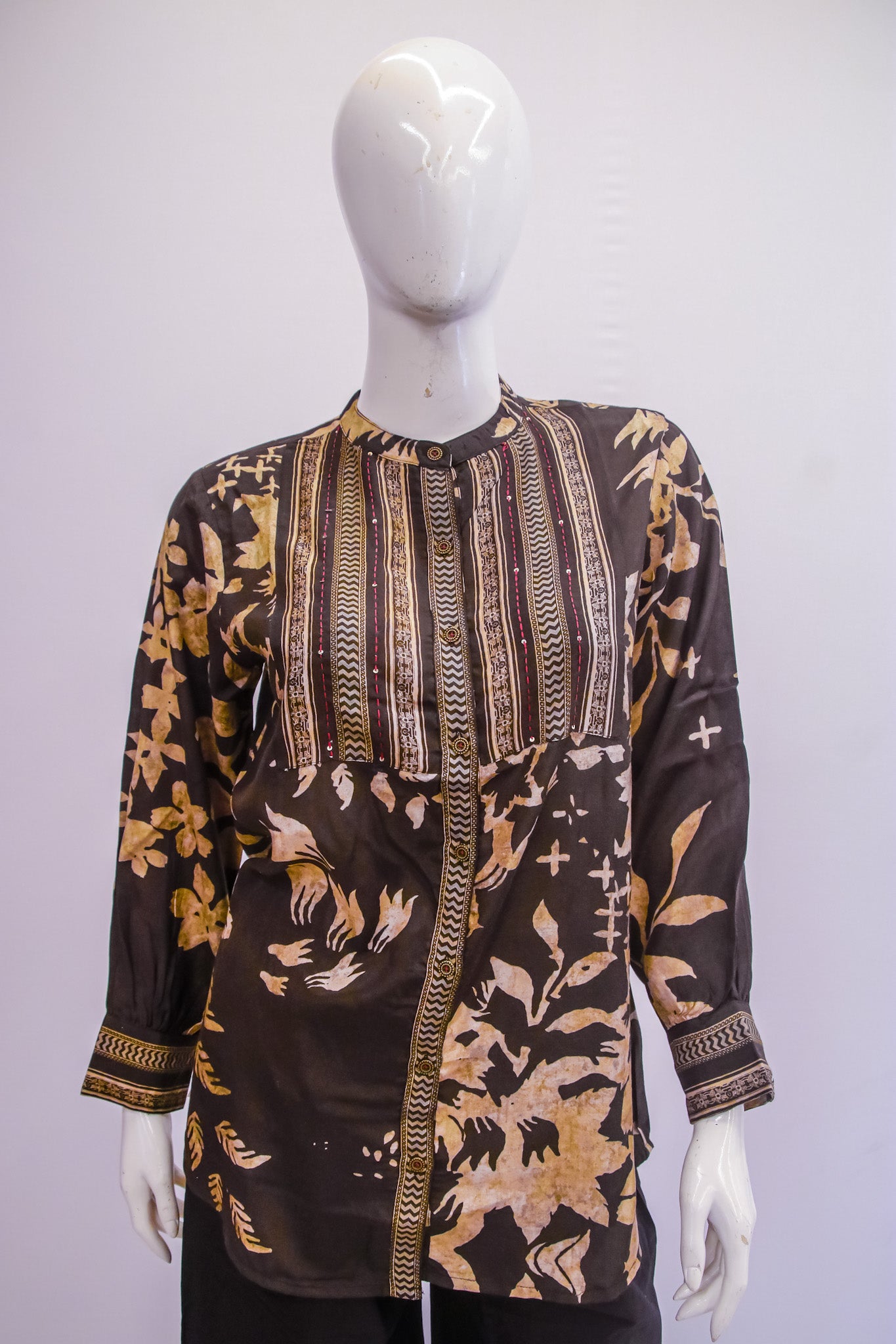 Mannequin wearing a patterned shirt with a white background