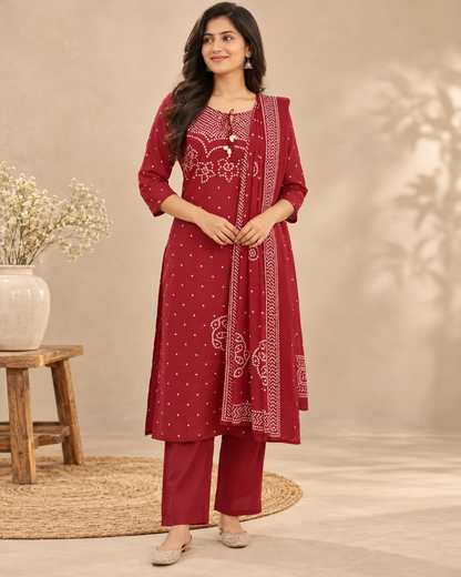 Red cotton Bandhani-print kurta pant set with white motifs, tassel neckline and matching printed dupatta.