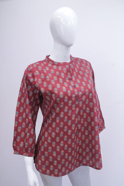 Red patterned shirt on a white mannequin against a white background