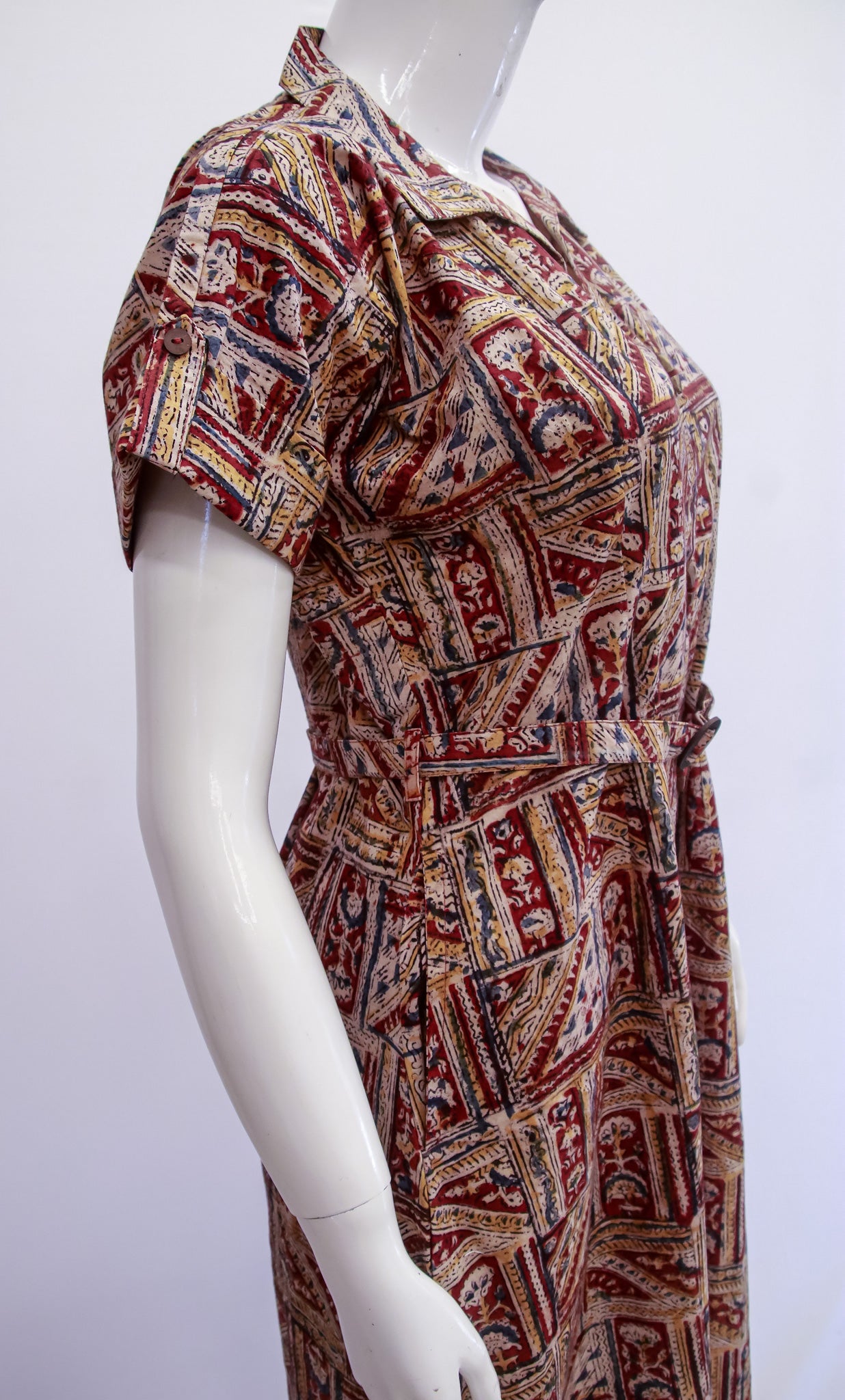 Mannequin wearing a patterned dress on a white background