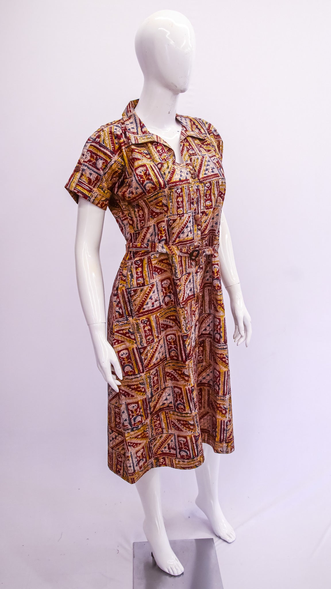 Mannequin wearing a patterned dress on a white background