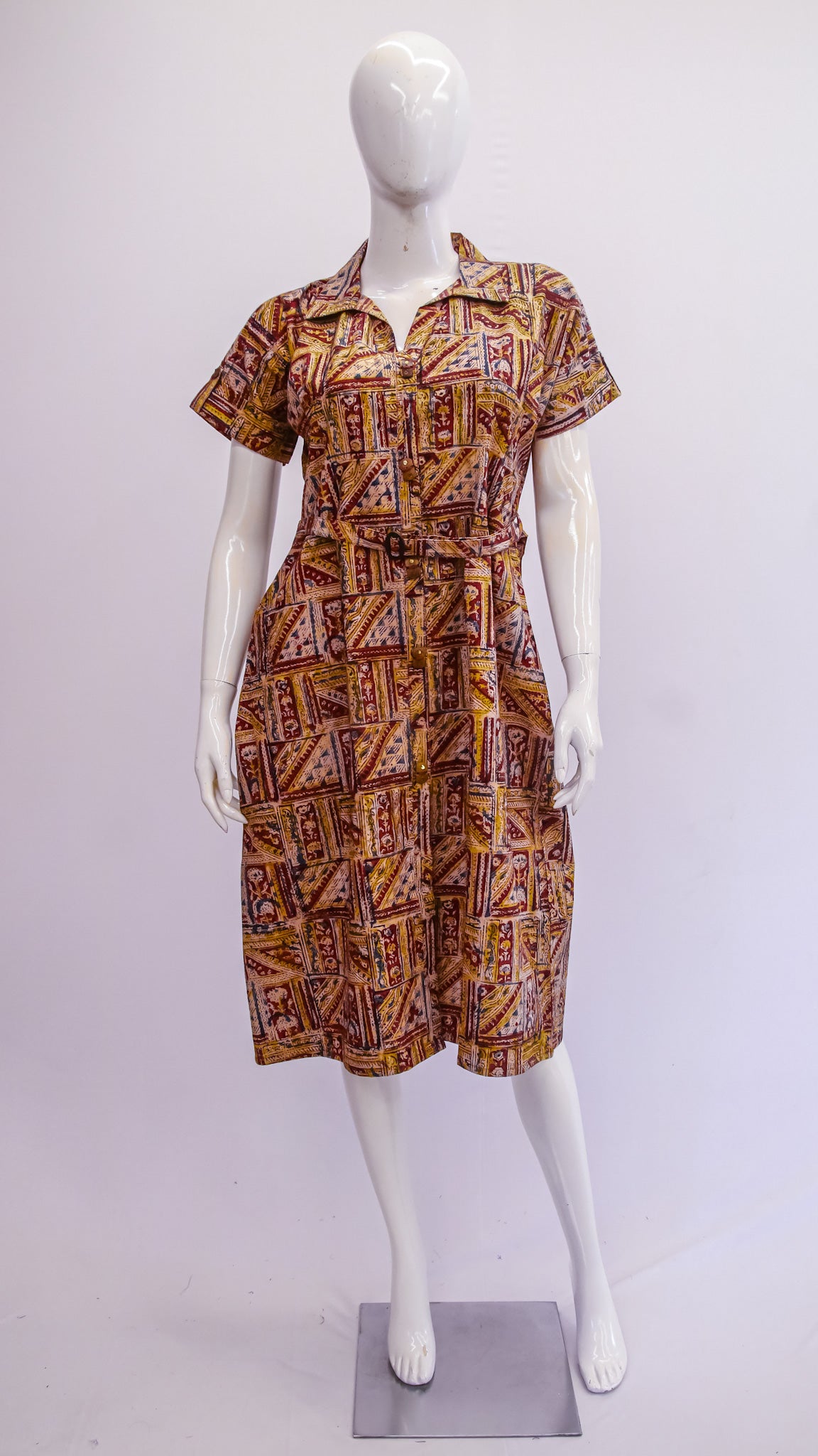 Mannequin wearing a patterned dress on a white background