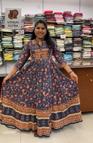 Woman wearing a patterned dress in a fabric store