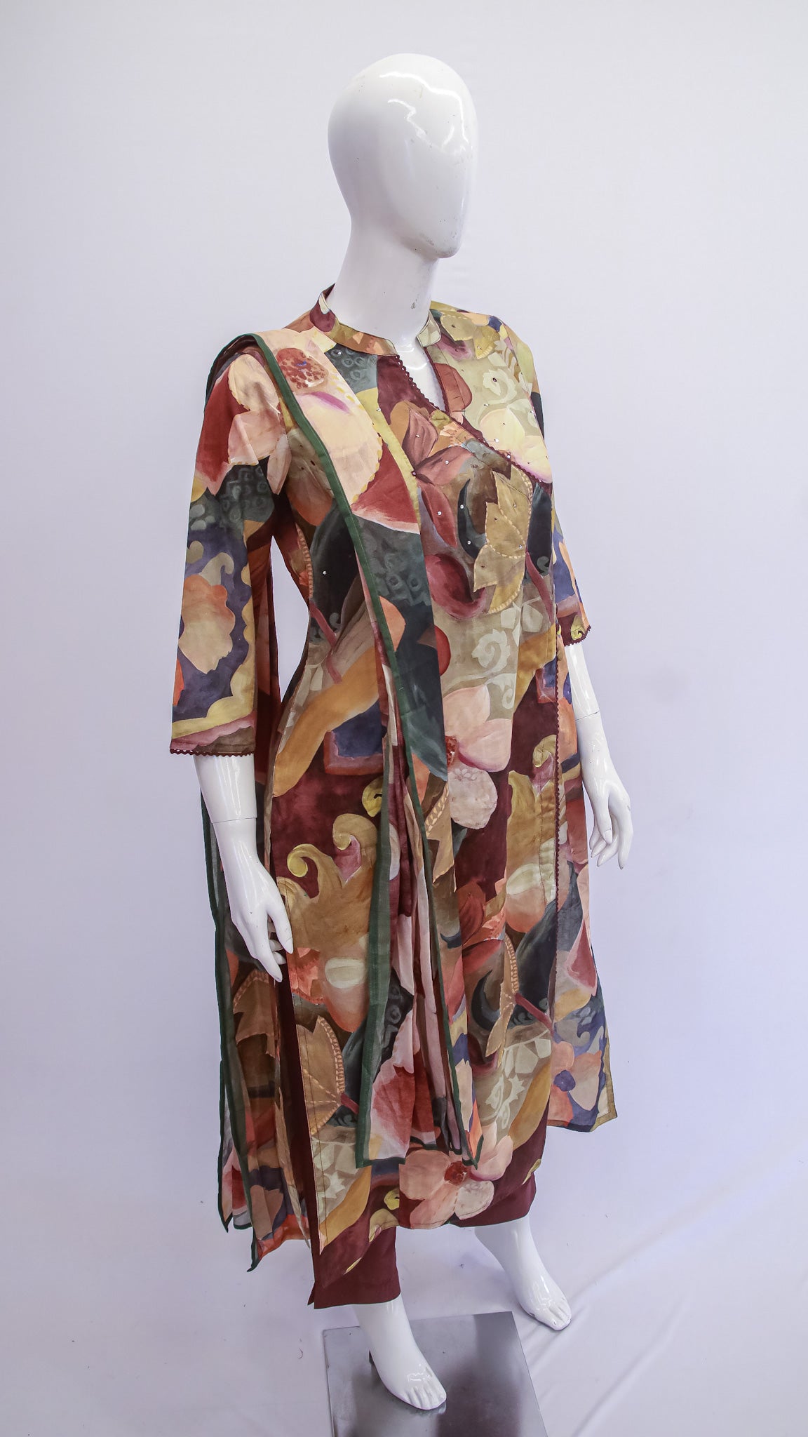 Mannequin wearing a colorful floral dress against a white background