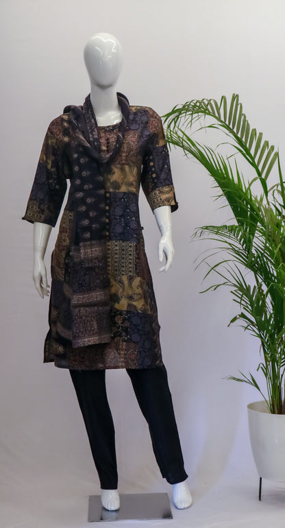 A mannequin displaying a black dupatta set with floral print, consisting of a kurta, pant, and dupatta, standing in a retail setting.