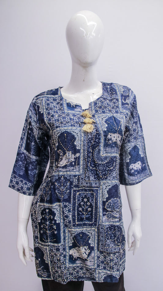 Blue patterned dress on a white mannequin against a white background