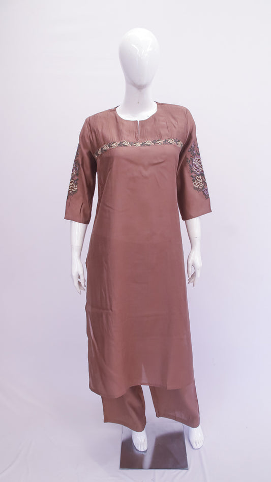 Brown dress with embroidered details on a mannequin against a white background
