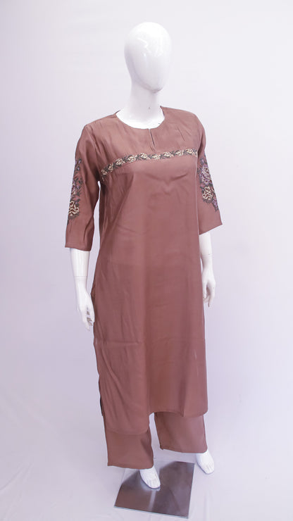 Brown dress with embroidery on a mannequin against a white background
