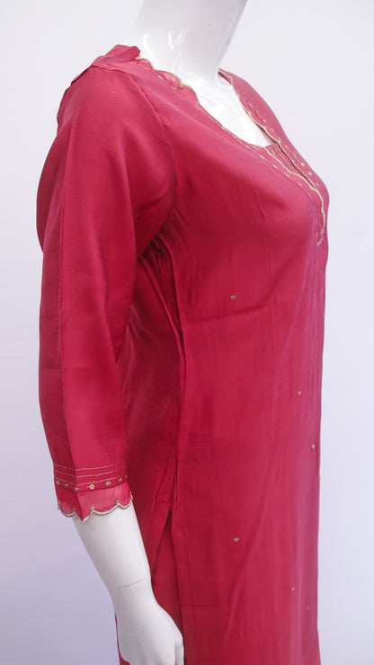 Red dress with lace details on a mannequin against a white background