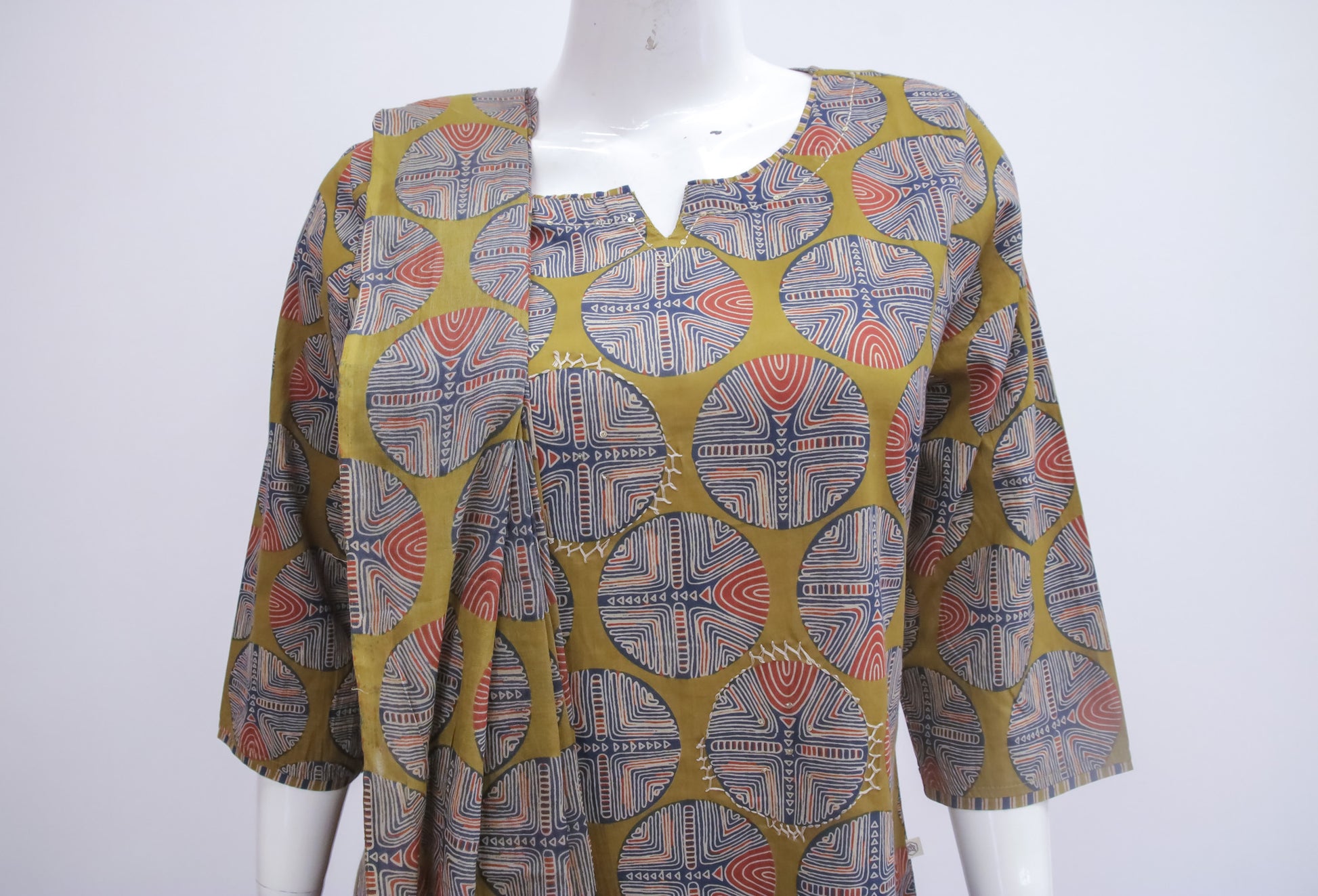 Patterned shirt on a mannequin against a white background