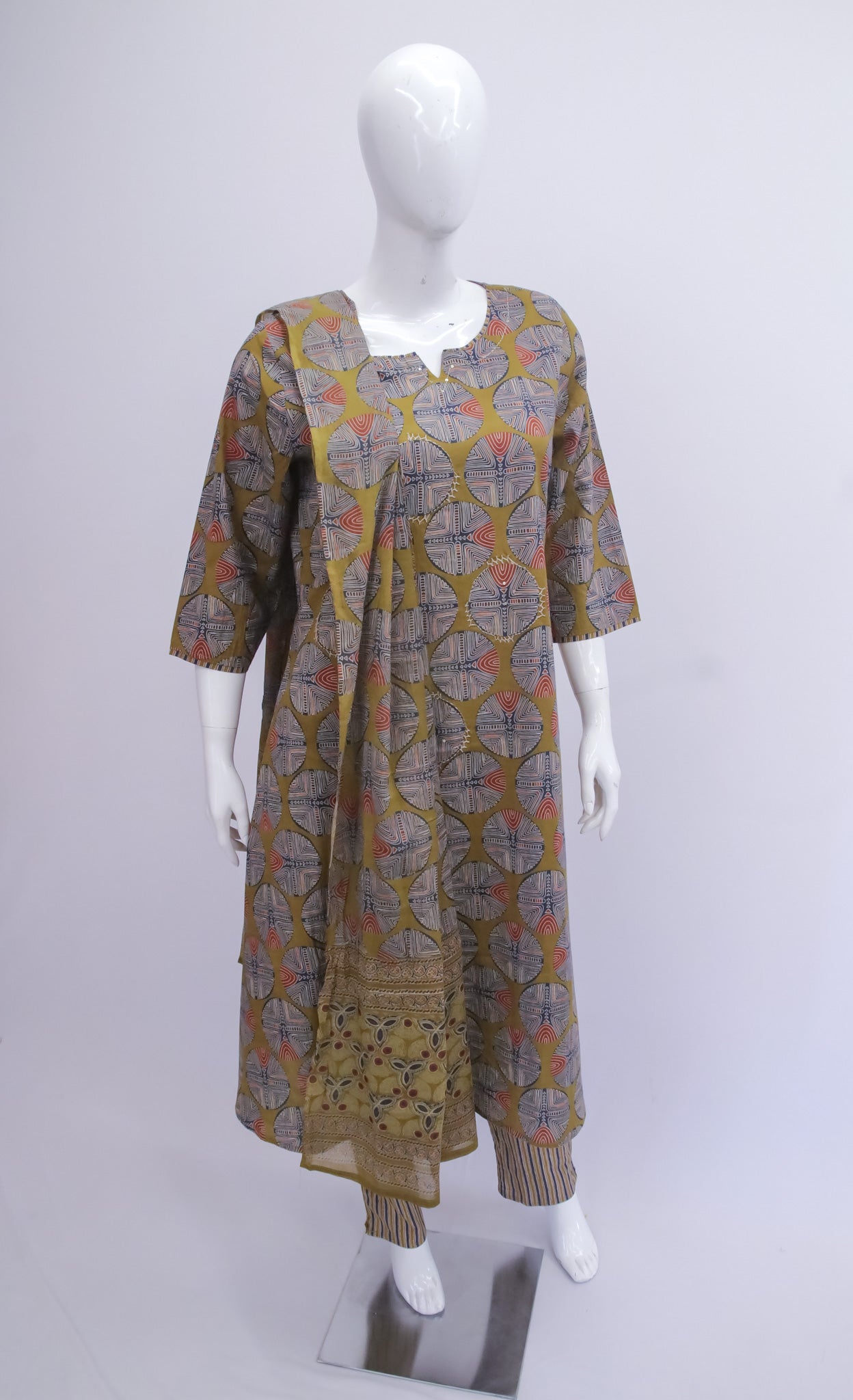 Mannequin wearing a patterned dress on a white background