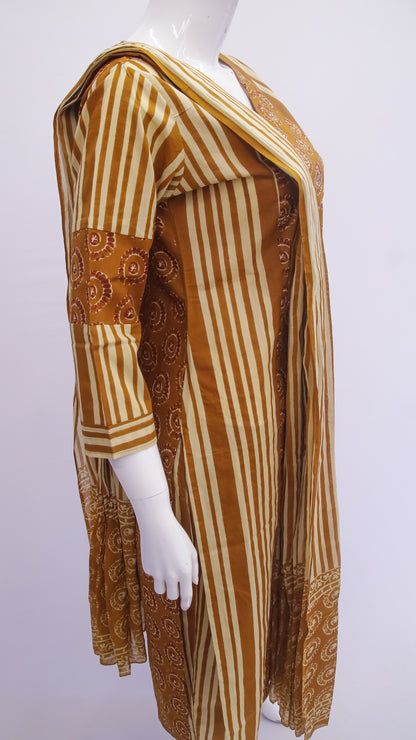 Mannequin wearing a long, patterned dress with vertical stripes and floral designs on a white background
