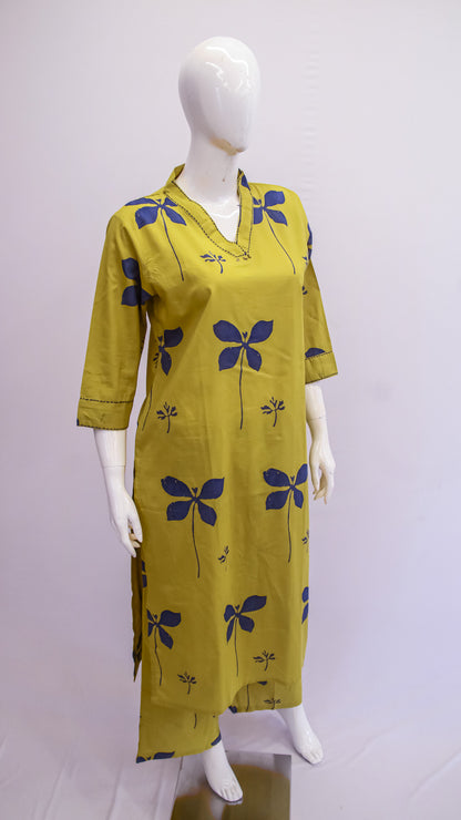 Yellow dress with blue floral patterns on a mannequin against a white background