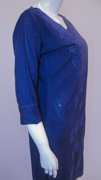 Blue dress with intricate patterns on a mannequin against a plain background