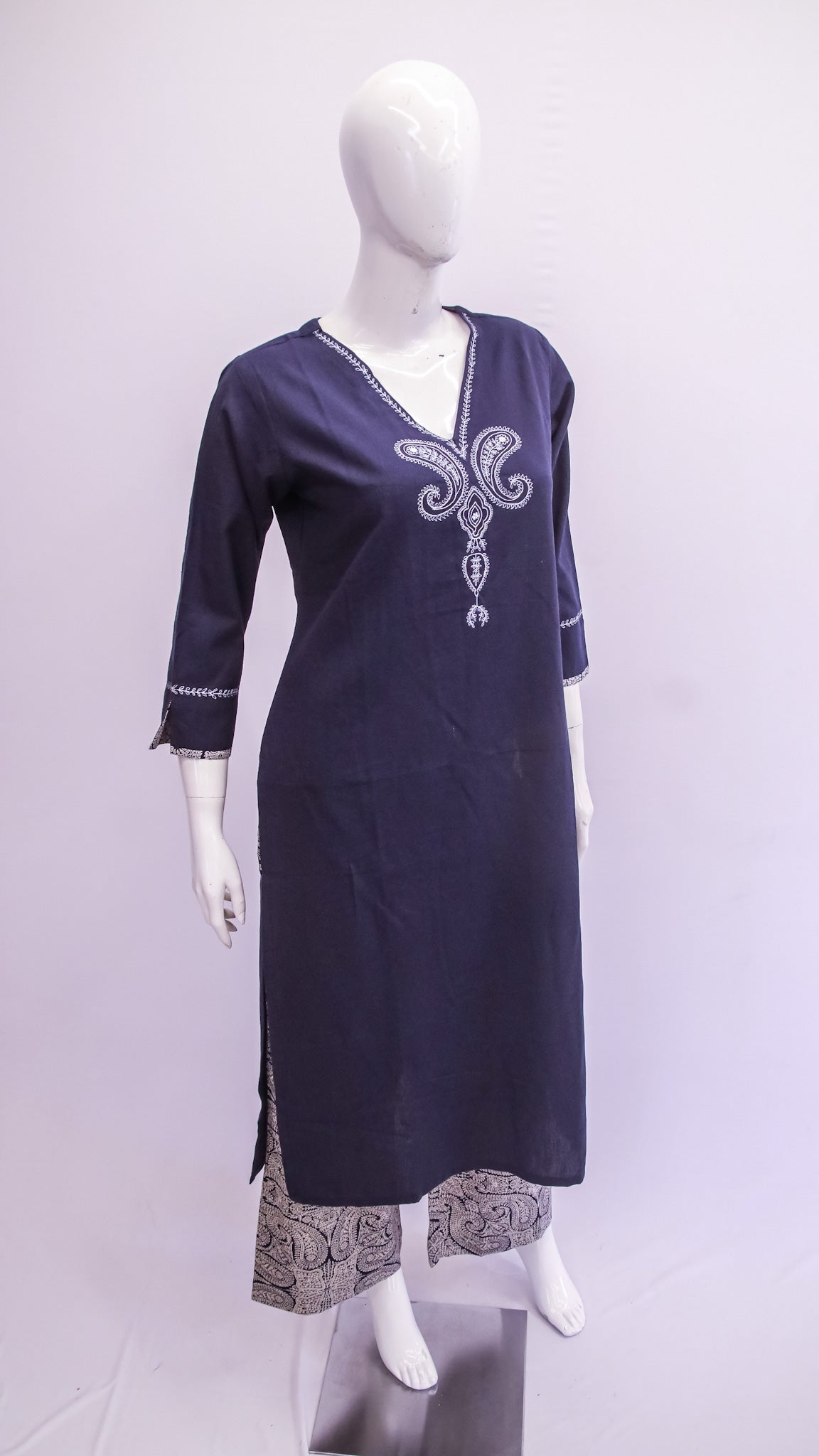 Navy blue kurta with white embroidery on a mannequin against a light gray background