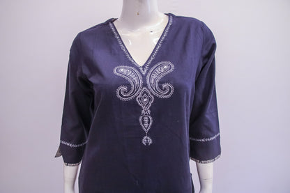 Navy blue blouse with white embroidery on a mannequin against a white background