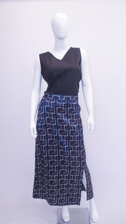 Mannequin wearing a black sleeveless top and patterned skirt on a white background